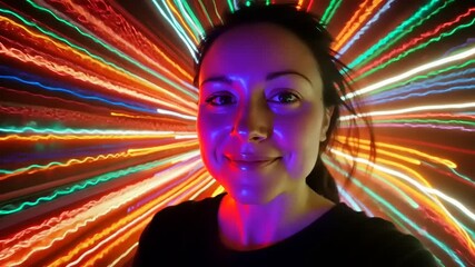 Vibrant portrait of a woman surrounded by colorful light trails, creating a dynamic and energetic atmosphere - Powered by Adobe