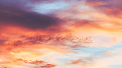 Fototapeta premium Dramatic sunrise with gradient orange and purple clouds, creating a panoramic abstract sky view.