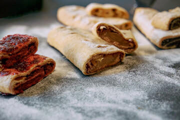 Delicious Homemade Pastries with Sweet Fillings Neatly Arranged on a Flour-Dusted Surface Ready for Enjoyment