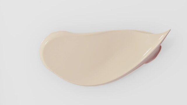 Smear foundation face make-up cream or beige concealer smudge with cosmetic spatula. Beauty texture background.