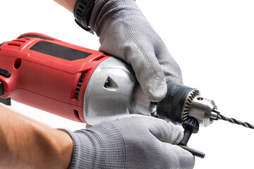 Closeup of worker hands holding electric drill on white background.