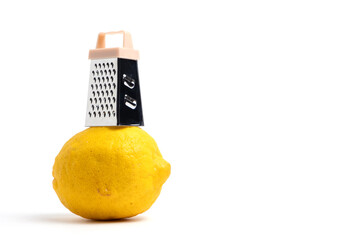 Lemon and grater isolated on white background with copy space.