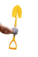 Hand in gray gloves holding yellow shovel is highlighted on white background.