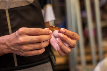 A man holds spices in his hand in the market