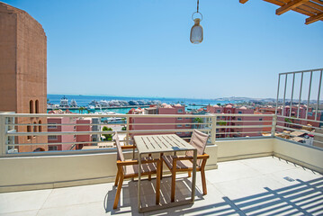 Roof patio terrace with chairs in tropical luxury apartment resort