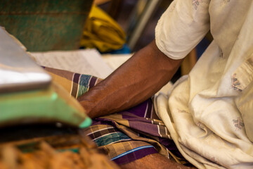 A man shows his leg on the fish table in the market