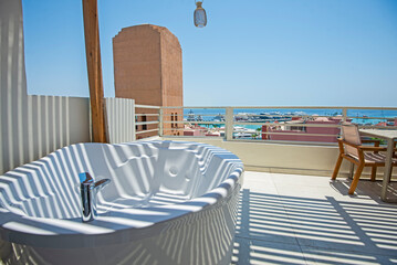 Roof patio terrace with hot tub in tropical luxury apartment resort