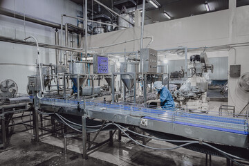 Quiet factory, few plant worker cleaning production line convey belt prepare to close food factory