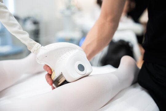 Professional treatment being applied to a patients leg in a clinic setting