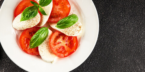 Caprese salad mozzarella and tomato, basil fresh delicious gourmet food background on the table rustic food top view copy space keto and paleo diet vegan and vegan food