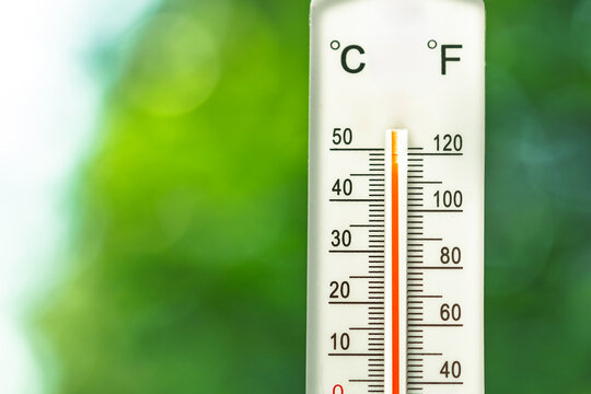 Dual scale outdoor thermometer showing extreme summer heat with Celsius and Fahrenheit readings