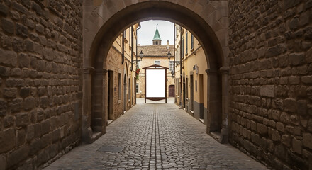 Fototapeta premium Historic European Alleyway with Blank Sign Perfect for Mockups and Travel Designs