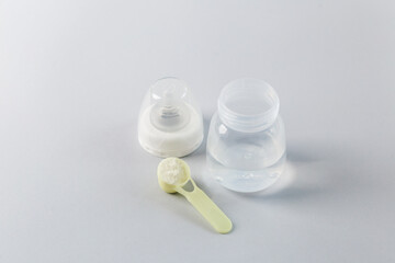 Baby formula preparation with bottle and scoop. Baby care.