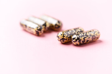Iron capsules on bright background. Soft focus. Close up. Copy space.	
