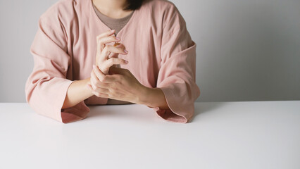 Asian business woman massaging wrist in pain Caused by working on a computer keyboard for a long time, wrist pain and numbness in the wrist. While working at the office