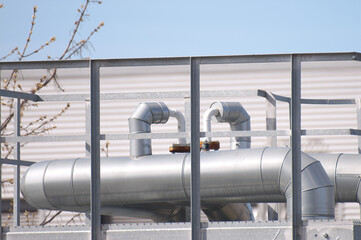 The photo shows close-up of pipeline elements at an industrial plant