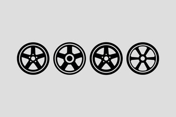 Four different car wheel designs in a row on a gray background