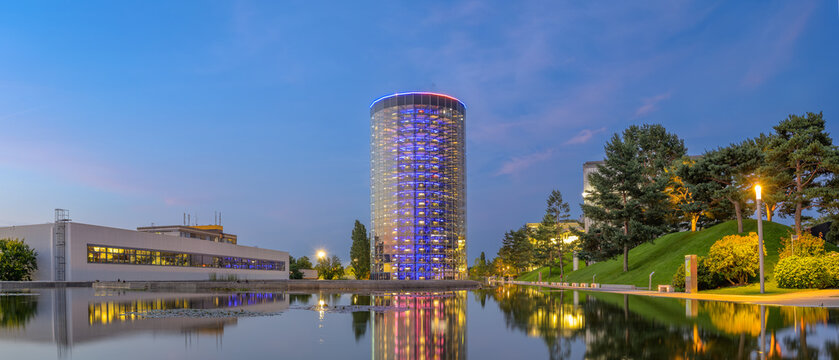 Wolfsburg, Germany - June 17, 2025: View of one the iconic car towers at Volkswagen Autostadt in Wolfsburg, Germany during twilight