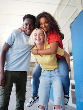 Happy Multicultural High School Students Laughing Together Outdoors