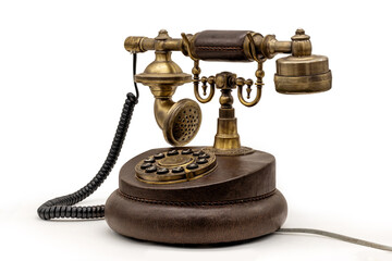 Antique rotary phone with brass details on white background