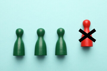 Dismissal. One red human figure with black cross among green ones on light blue background, top view