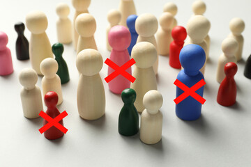 Dismissal. Three human figures with red crosses among others on white table