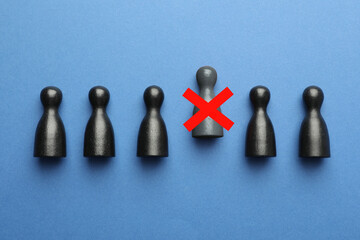 Dismissal. One grey human figure with red cross among others on blue background, top view