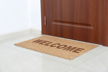 Welcome mat on floor near front door
