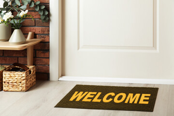 Welcome mat on floor near door in room