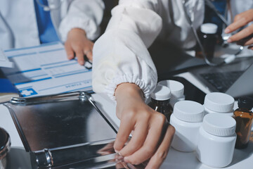 Male and female doctors are having a meeting in a hospital room.