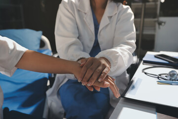 The doctor is checking and encouraging the patient.