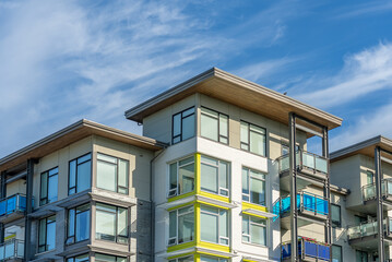 Naklejka premium Top of modern apartment building with balcony, trees and beautiful landscape in Vancouver, Canada, North America. Day time on June 2025.