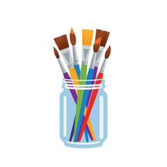 Obraz premium Colorful paintbrushes in a glass jar.