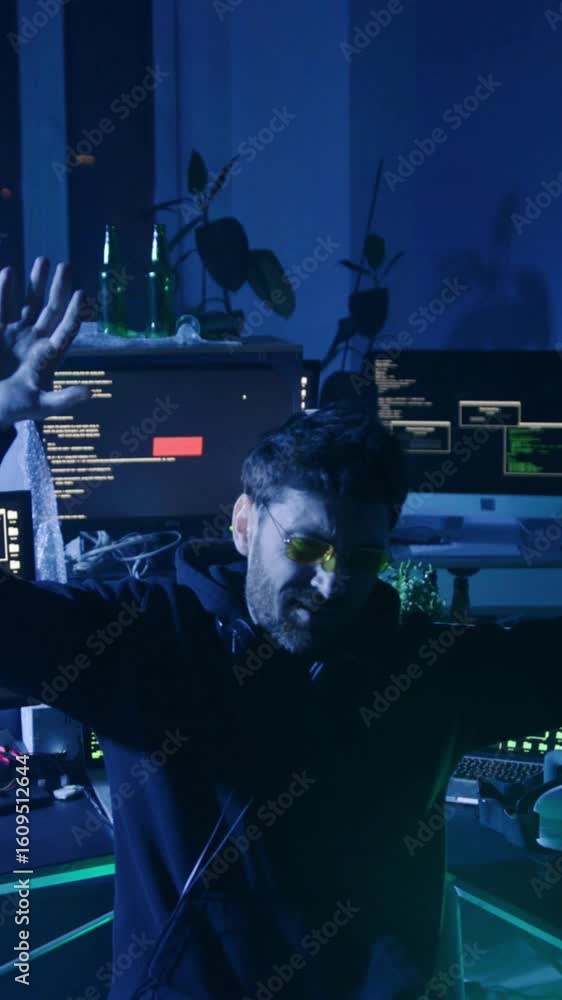 Poster a man interacts with a computer in a dim, techsavvy room