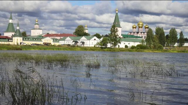 View from the water at Valdai Iversky Svyatoozersky Virgin Monastery for Men. Selvitsky Island, Valdai Lake. View of the Valdai Iversky Bogoroditsky svyatoozersky monastery. Sunny June day,