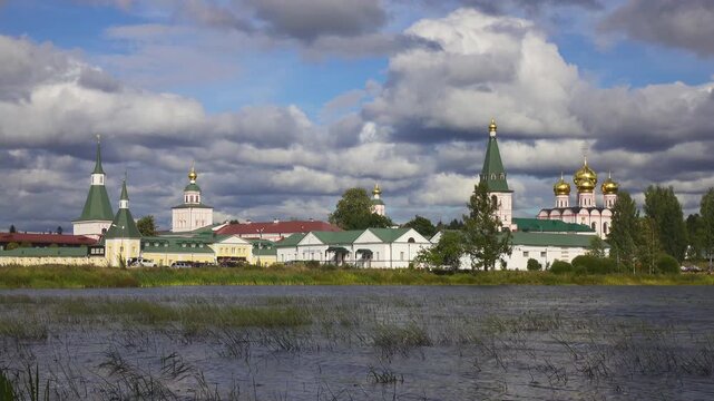 View from the water at Valdai Iversky Svyatoozersky Virgin Monastery for Men. Selvitsky Island, Valdai Lake. View of the Valdai Iversky Bogoroditsky svyatoozersky monastery. Sunny June day,