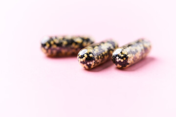Iron capsules on bright background. Soft focus. Close up. Copy space.	