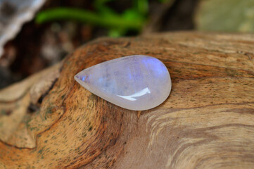 Moonstone gem on wood background 