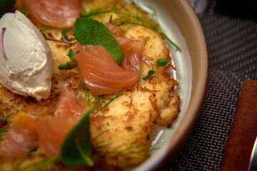 Delightful Dish Featuring Crispy Hash Browns Topped with Luxurious Smoked Salmon, Fresh Herbs, and Creamy Garnish, Perfect for Gourmet Dining Experiences