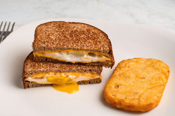fried egg melt sandwich with hash browns