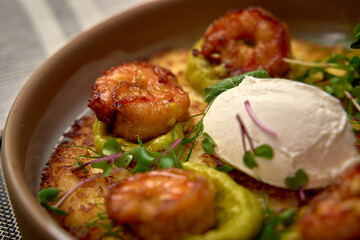 Delicious Shrimp and Avocado Dish Topped with Creamy Irresistible Sauce on a Golden Crispy Base,...