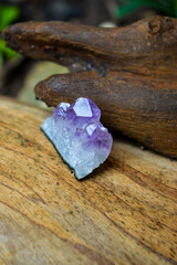  Amethyst mineral gem on wood background 