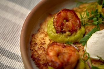 A Delicious Platter of Pan-Seared Shrimp on a Bed of Creamy Avocado Puree, Served with Fresh Herbs...