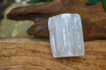  Selenite mineral gem on wood background 