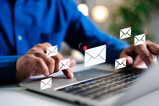 A Businessman working on a laptop open an email with triangle caution warning sign for notification error and maintenance concept, network security, computer virus detected, personal data protection.