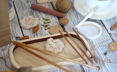 Knitting process, needles, cup of tea and different objects on the table beautiful photo
