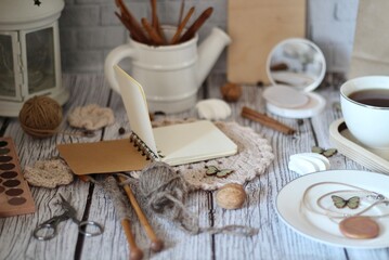 Knitting process, needles, cup of tea and different objects on the table beautiful photo
