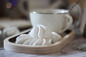 Cup of coffee, meringues, notepad diary and different woman things handmade art decor on wooden background table cozy photo	
