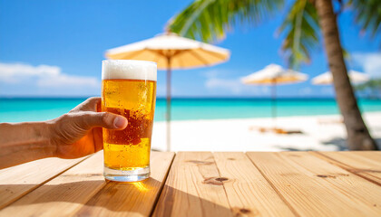 close up de la mano de una persona con una cerveza fria y dorada con espuma en una mesa de cervecería de playa junto al mar en vacaciones