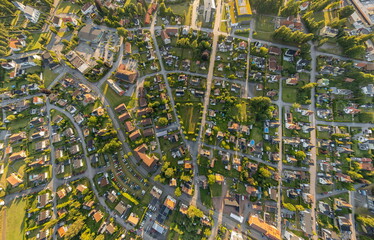 Wide-angle aerial panorama of a small Swedish town with residential and private houses, streets, greenery, and urban infrastructure, captured by drone
